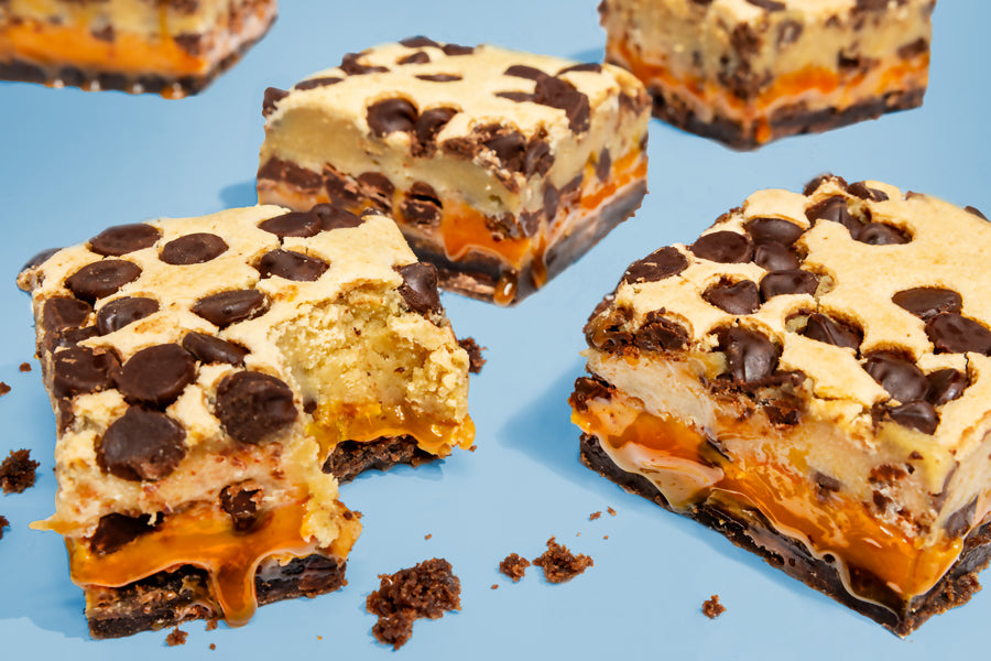 Image of bitten Cookie Dough Brownies layered with caramel center