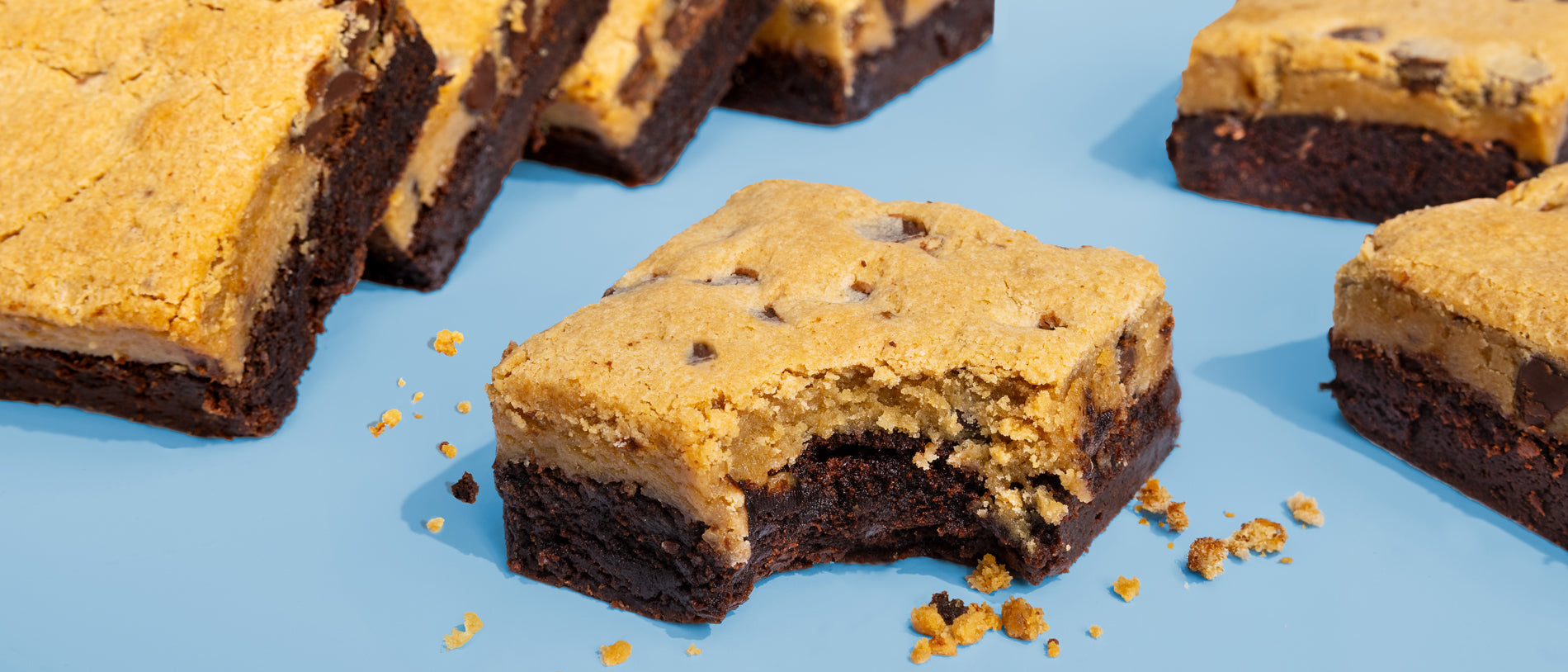 Image of bitten Brookie Brownies on blue background