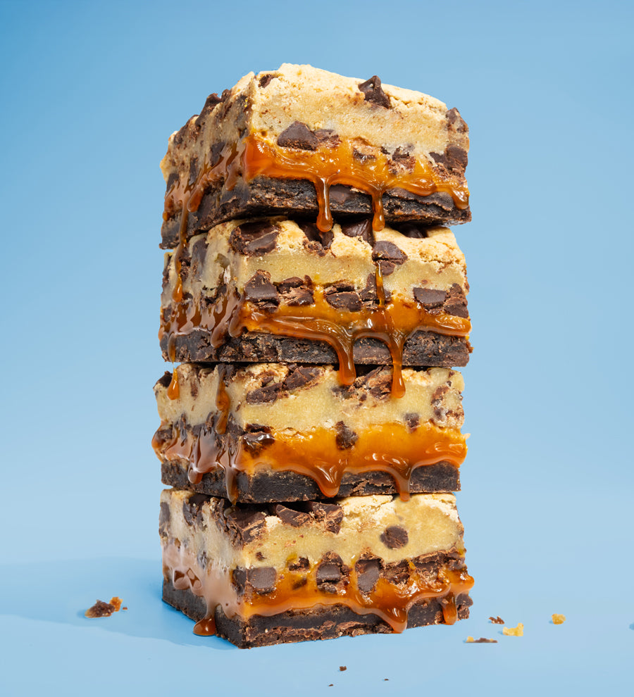 Image of stacked Killer Brownie Cookie Dough Topped with caramel layered brownies