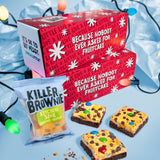 Red gift box with festive text, brownies, and a bag labeled 'Killer Brownie Kitchen Sink' on a light blue background.