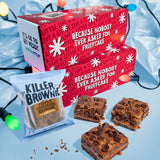 Red holiday-themed box with brownies and a brownie mix packet on a light blue background.