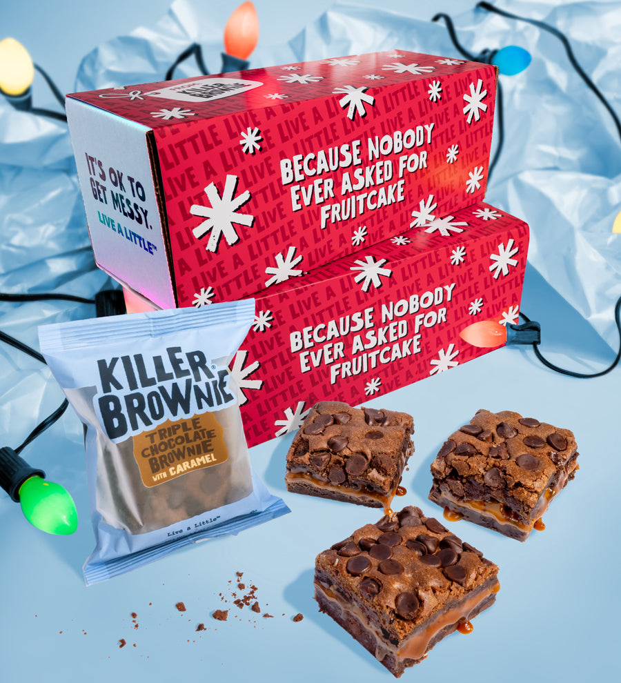 Red holiday-themed box with brownies and a brownie mix packet on a light blue background.