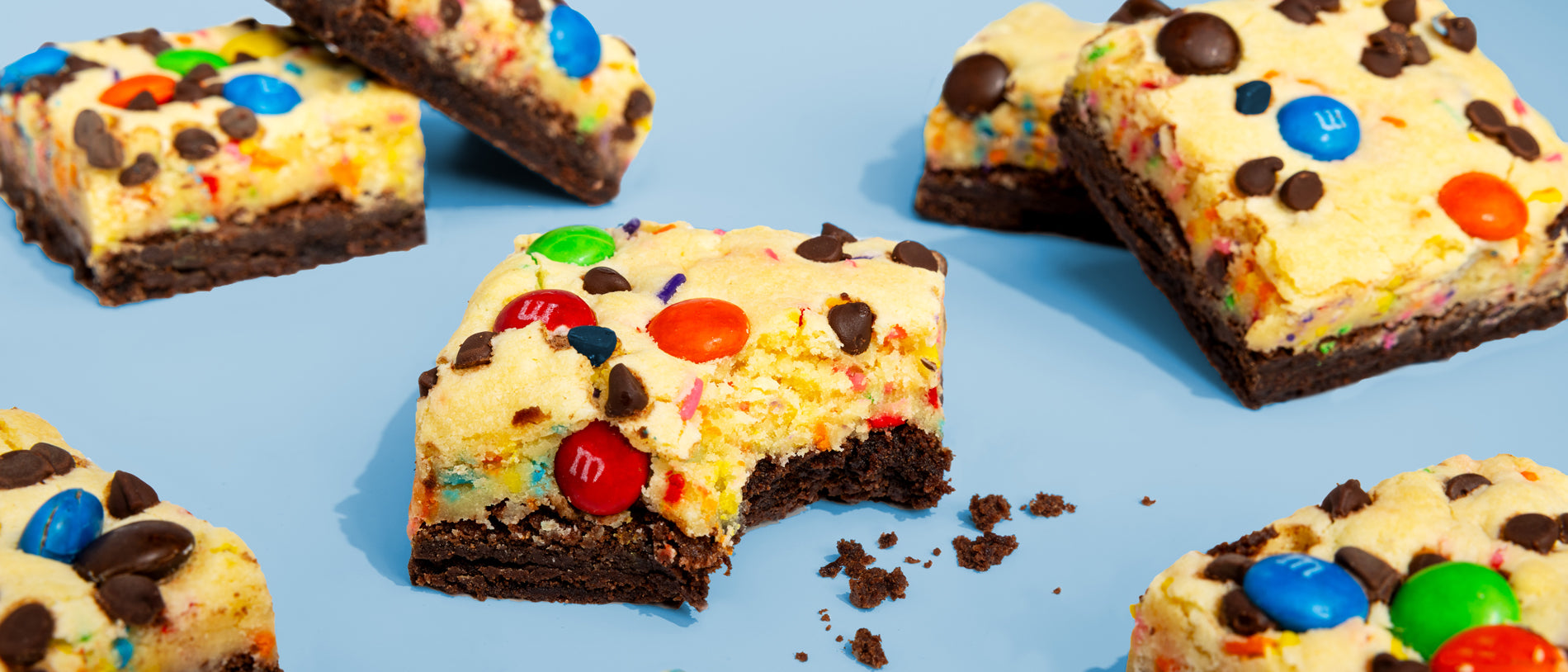 Image of bitten Kitchen Sink Brownies on blue background