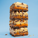 Image of stacked Killer Brownie Cookie Dough Topped with caramel layered brownies